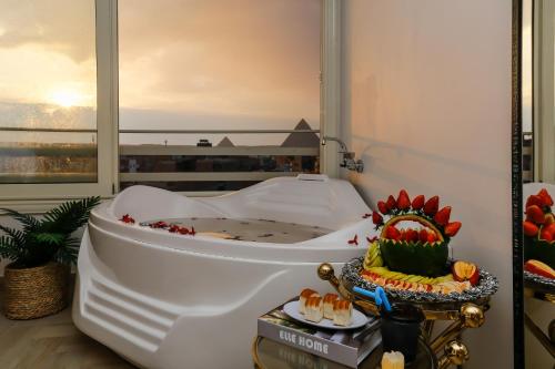 a white bath tub with a cake on top of it at Rixoss Tower Pyramids View in Cairo