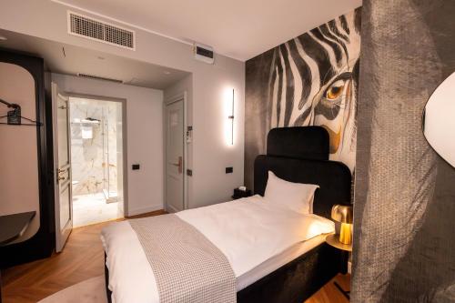 a bedroom with a bed with a zebra painting on the wall at Ecletico Villa in Bucharest