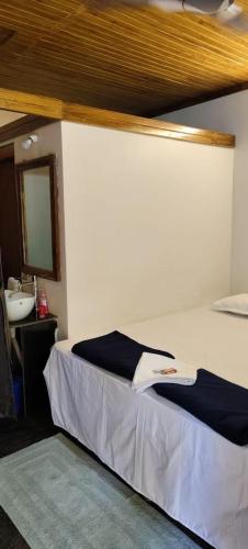 a bedroom with a bed with a sink and a mirror at Niyati Home Stay in Gokarna