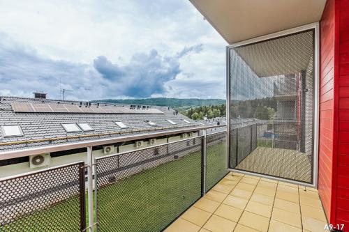 a balcony with a view of a building at KORZO LIPNO 2 in Lipno nad Vltavou