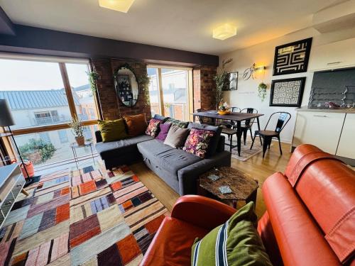 a living room with a couch and a table at #12 Stylish Canalside Loft with Parking in Coventry