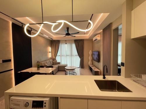 a kitchen and living room with a ceiling fan at Alfa Bangsar by The Homez in Kuala Lumpur