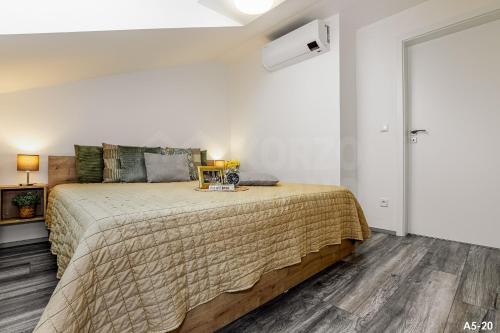 a bedroom with a large bed in a room at KORZO LIPNO 2 in Lipno nad Vltavou