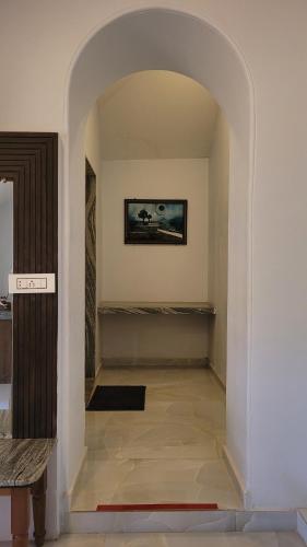 a hallway with an archway in a house at Madhuvan Retreat Resort Amba in Chandoli