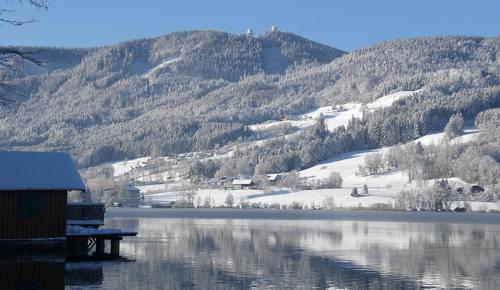 a view of a lake with a snow covered mountain at CK Apartment in Oberhofen am Irrsee