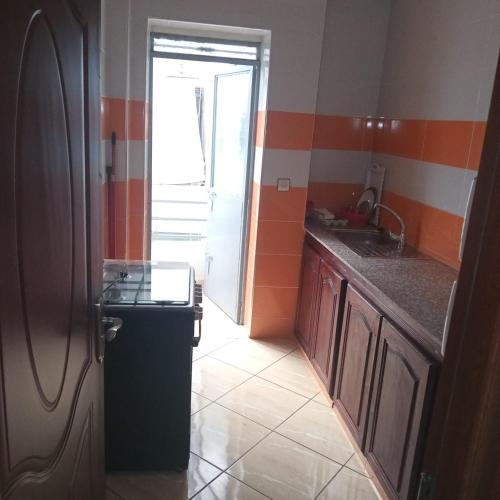 a small kitchen with a sink and a counter at Dar lara in Larache