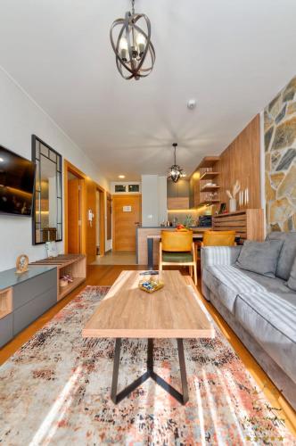 a living room with a couch and a table at King's Square Lux apartment Zlatibor 2 in Zlatibor