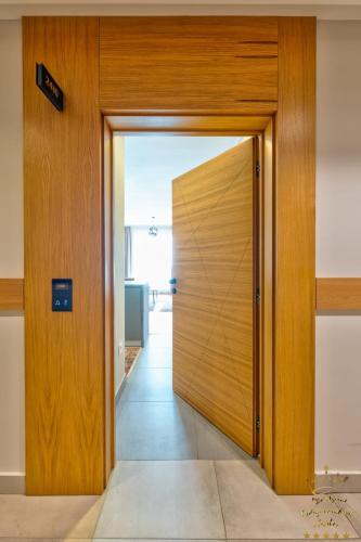 a wooden door in a room with a hallway at King's Square Lux apartment Zlatibor 2 in Zlatibor