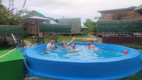a group of people in a swimming pool at Nirvana bamboo houses & dive centre in Moalboal