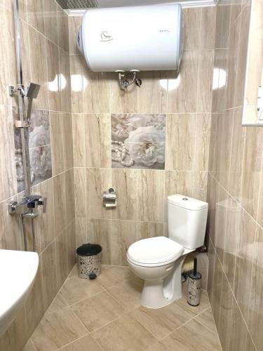 a bathroom with a toilet and a sink at VN Home 1 in Pomorie