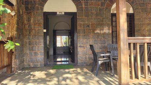 an open door of a building with a table and chair at Madhuvan Retreat Resort Amba in Chandoli