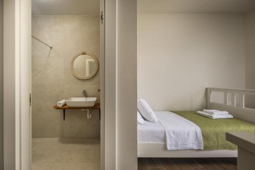 a small bathroom with a bed and a sink at Villa Santa Lucia ZadarVillas in Turanj