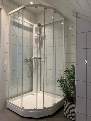 a shower with a glass enclosure in a bathroom at Hytteperle in Risør