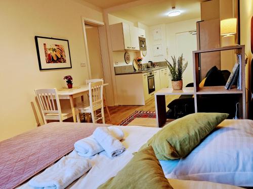 a bedroom with a bed with towels on it at LIVE-INN PRAGUE APARTMENTS, Free Gym & Parking, Reception, Lifts, Roof Terrace & Game Room in Prague