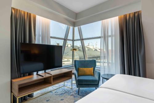 a hotel room with a tv and a large window at Wyndham Wroclaw Old Town in Wrocław
