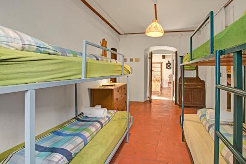 a room with three bunk beds and a hallway at Historical Caslano Apartments - Happy Rentals in Caslano