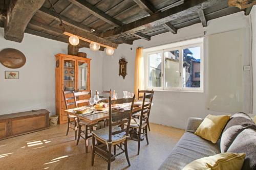 a living room with a wooden table and chairs at Historical Caslano Apartments - Happy Rentals in Caslano