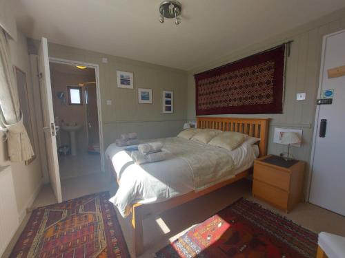a bedroom with a large bed and a rug at Garragh Mhor in Oban