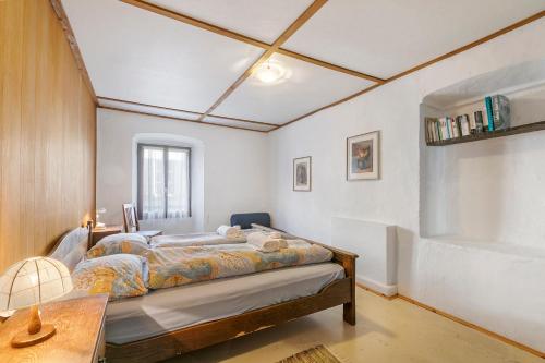 a bedroom with a bed and a table with a lamp at Historical Caslano Apartments - Happy Rentals in Caslano