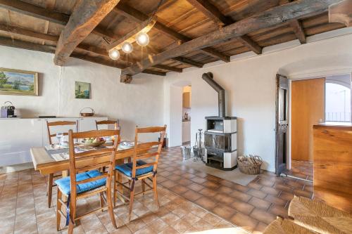 a kitchen and dining room with a table and a stove at Historical Caslano Apartments - Happy Rentals in Caslano