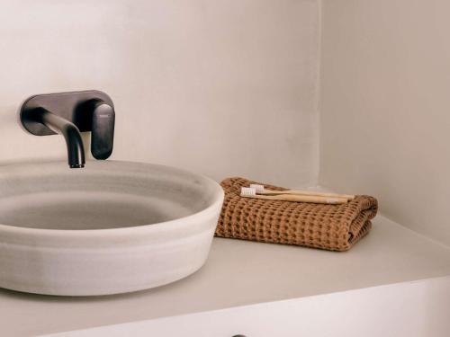a sink with a faucet on top of a counter at Mondrian Ibiza in Cala Llonga