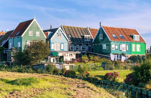 a group of houses on top of a hill at Surla Houseboat "De Albatros" in Monnickendam Tender included in Monnickendam
