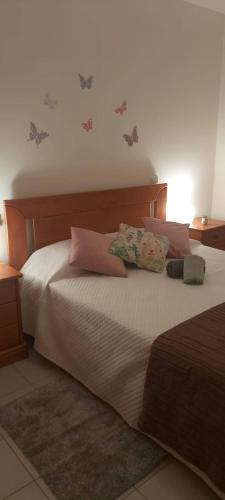 a bedroom with a large bed with pillows on it at Holiday Spot in Portimão