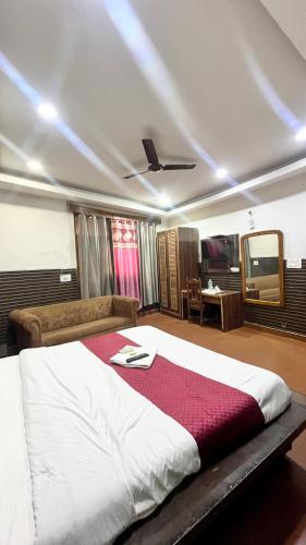 a bedroom with a large bed with a red blanket at HOTEL Royal Plaza in Chandīgarh