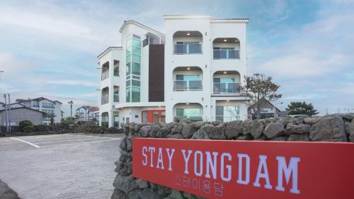 a sign in front of a building at Stay Yongdam in Jeju