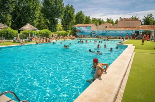 a group of people in a large swimming pool at Camping 4 etoiles - Espace aquatique - 500m plage - ccagefg in Portiragnes