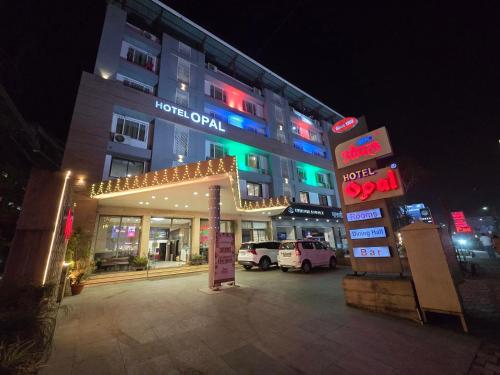 a hotel at night with a lit up sign at Hotel Opal in Kolhapur