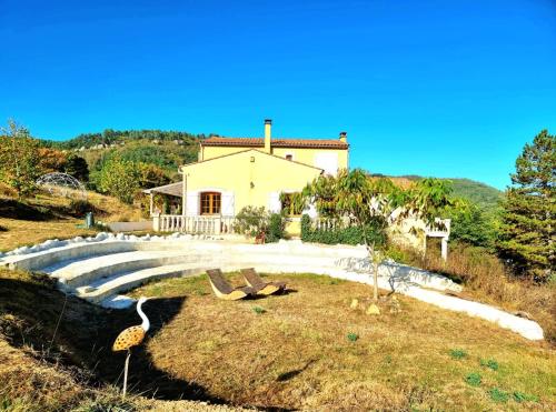 a house on top of a hill with a house at Centre Harmonia in Rennes-les-Bains