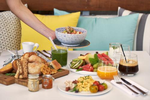 a table with a tray of food on it at Icon Suites by the sea in Potos
