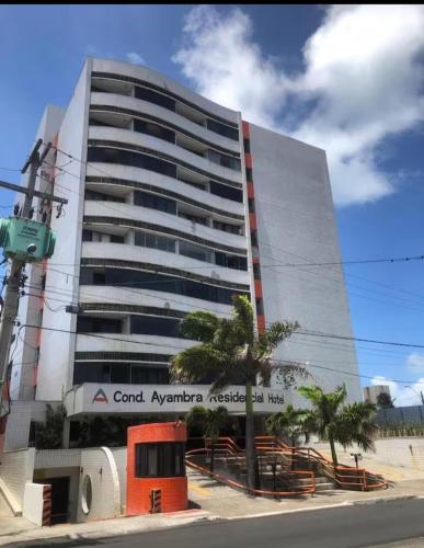 a building with a sign on the side of it at Residencial Ayambra in Natal