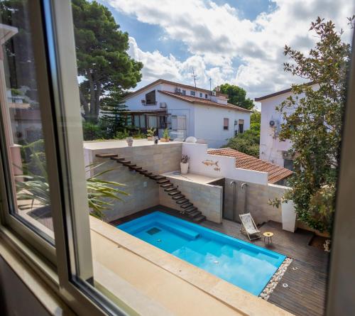 a view of a swimming pool from a window at Villa Olimpia in Mondello