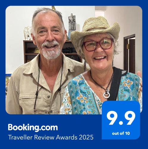 an older man and woman standing next to each other at Emerald Home Stay in Anuradhapura