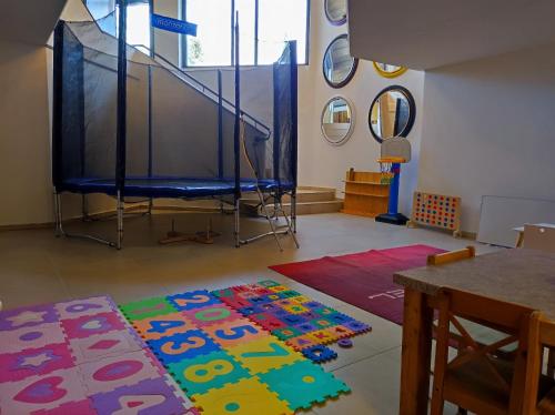 a room with a table and a rug on the floor at Vitalhotel Gosau in Gosau