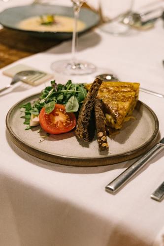a plate of food sitting on a table at ECOTurisme Can Buch HOTEL in Sant Aniol de Finestras