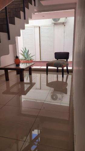 a room with a table and a chair on a floor at Hotel Aiello in San Luis
