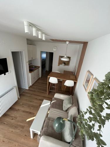 a living room with a couch and a table at Sleep&Fly Zagreb AIRPORT APARTMENTS in Velika Gorica