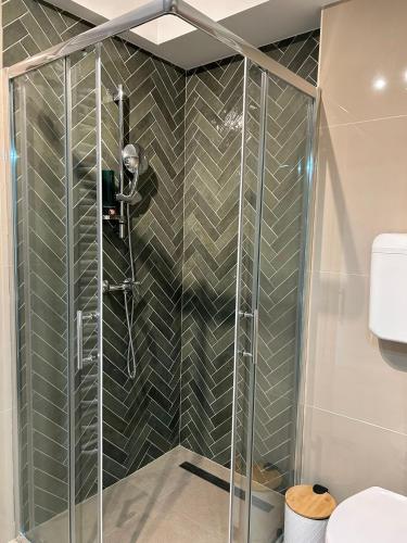 a shower with a glass enclosure in a bathroom at Sleep&Fly Zagreb AIRPORT APARTMENTS in Velika Gorica