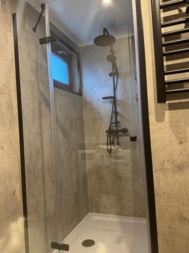 a shower in a bathroom with a glass door at Harmony Park in Kondrajec