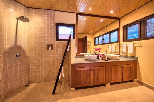 a bathroom with two sinks and a shower at Baan Buaa - Beachside 3 Bed Pool Villa in Hua Thanon Beach