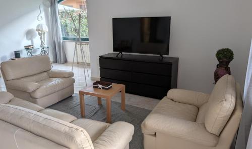 a living room with two couches and a flat screen tv at Villa Fabiani in Fonte Nuova