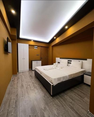 a bedroom with a large bed in a room at Grand Ayhan Hotel Kuşadası in Kusadası