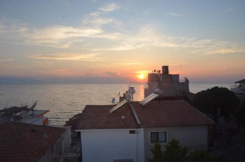 a view of the sun setting over the ocean at Grand Ayhan Hotel Kuşadası in Kusadası