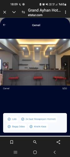 a picture of a kitchen with two red chairs at Grand Ayhan Hotel Kuşadası in Kusadası