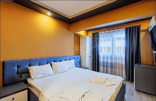 a bedroom with a large bed and a window at Grand Ayhan Hotel Kuşadası in Kusadası