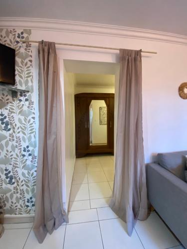 - un salon avec un rideau et un canapé dans l'établissement Appartement Nîmes B, à Nîmes