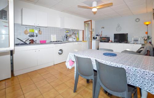 a kitchen with a table and chairs in a kitchen at Lovely Home In San Gavino Di Fiumorbo in San-Gavino-di-Fiumorbo